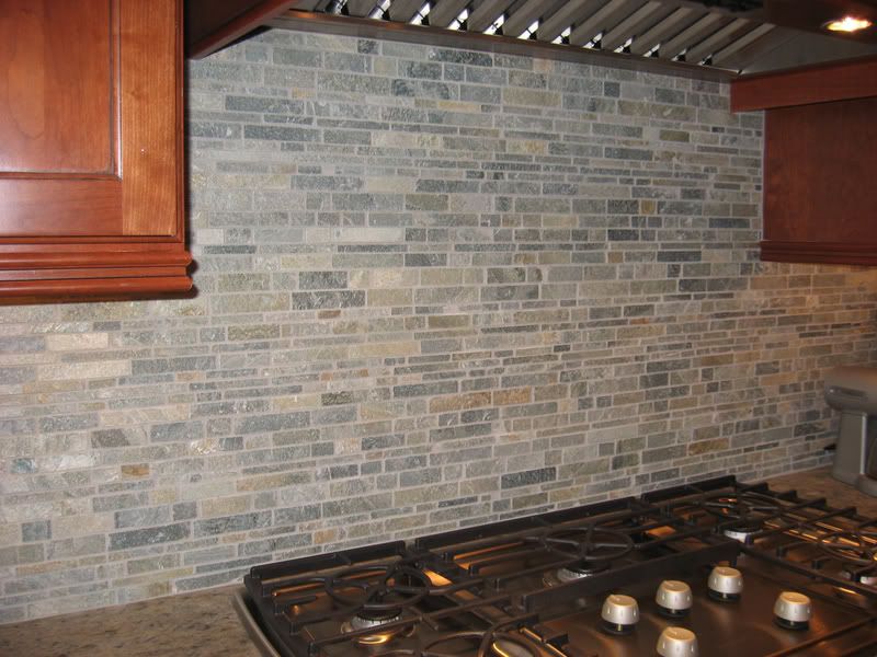 everything tuscany mural with italian chef in stacked stone backsplash