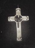 Fabricated cross with hanging feather.