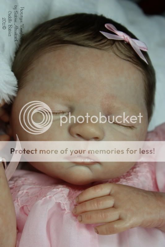 Emmylou has hand rooted, wispy baby eyelashes in brown to match her