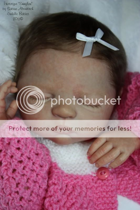 Emmylou has hand rooted, wispy baby eyelashes in brown to match her